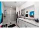 Bathroom with double vanity, granite countertop, and a walk-in shower at 781 Marion Oaks Trl, Ocala, FL 34473