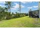 Screened patio with a hammock and lush green lawn at 781 Marion Oaks Trl, Ocala, FL 34473