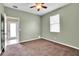 Bright bedroom with ceiling fan, carpet, and access to exterior at 2029 Madison Ivy Cir, Apopka, FL 32712