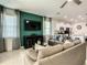 Open living room features a large TV, comfortable seating, and kitchen views at 4791 Terrasonesta Dr, Davenport, FL 33837