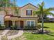 Two-story townhome with red shutters and a landscaped yard at 4791 Terrasonesta Dr, Davenport, FL 33837