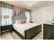 Bedroom with a king-size bed, unique headboard, and plenty of natural light at 4791 Terrasonesta Dr, Davenport, FL 33837