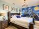 Main bedroom with Hogwarts mural and a large bed at 4791 Terrasonesta Dr, Davenport, FL 33837