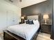 Bedroom with dark-accent wall and double doors at 4791 Terrasonesta Dr, Davenport, FL 33837