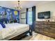 Main bedroom with Hogwarts mural, TV, and dresser at 4791 Terrasonesta Dr, Davenport, FL 33837