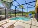 Inviting screened pool and patio with lounge chairs and a tranquil view at 4791 Terrasonesta Dr, Davenport, FL 33837