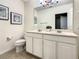 Double vanity bathroom with a large mirror at 4791 Terrasonesta Dr, Davenport, FL 33837