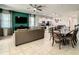 Open living room and kitchen with an accent wall, tile floors, and modern furnishings at 4791 Terrasonesta Dr, Davenport, FL 33837