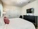 Main bedroom with a king-size bed, dresser, and chandelier at 4791 Terrasonesta Dr, Davenport, FL 33837