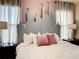 King-size bed with a castle headboard and soft pink accents at 4791 Terrasonesta Dr, Davenport, FL 33837