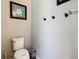 Simple bathroom with toilet and wall-mounted storage at 4791 Terrasonesta Dr, Davenport, FL 33837