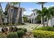 Modern home with gray stone and white accents, palm trees, and a paved driveway at 9721 Carillon Park Dr, Windermere, FL 34786