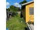 View of a backyard with overgrown grass at 709 N Disston, Tavares, FL 32778