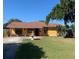 Ranch style home with mature landscaping and a fountain at 709 N Disston, Tavares, FL 32778