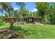 House exterior with a covered patio, picnic table and lush landscaping at 1099 Bee Ln, Geneva, FL 32732