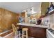 Small kitchen with wood cabinets, a breakfast bar, and a window at 1099 Bee Ln, Geneva, FL 32732