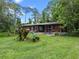 House exterior with a covered patio and picnic table at 1099 Bee Ln, Geneva, FL 32732