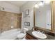 Clean bathroom with tub, vanity with granite countertop, and framed mirror at 901 Charo Pkwy # 732, Davenport, FL 33897
