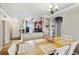 Bright dining area with a wooden table and white chairs, adjacent to kitchen at 901 Charo Pkwy # 732, Davenport, FL 33897