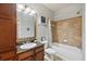 Clean bathroom with a tub, vanity with granite countertop and a framed mirror at 901 Charo Pkwy # 732, Davenport, FL 33897