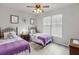 Twin bedroom with two beds, nightstands, and ceiling fan at 901 Charo Pkwy # 732, Davenport, FL 33897