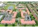 Aerial view showing multiple residential buildings, parking, and a pond at 901 Charo Pkwy # 732, Davenport, FL 33897
