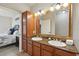 Double vanity bathroom with granite countertops and large mirror at 901 Charo Pkwy # 732, Davenport, FL 33897