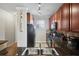 Well-equipped kitchen featuring dark wood cabinets and granite countertops at 901 Charo Pkwy # 732, Davenport, FL 33897