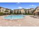 Community pool with lounge chairs and a pergola at 901 Charo Pkwy # 732, Davenport, FL 33897