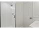 Modern bathroom with a walk-in shower, white tile, and black accents at 6165 Carrier Dr # 1206, Orlando, FL 32819