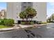 Building exterior with palm trees and parking area at 6165 Carrier Dr # 1206, Orlando, FL 32819