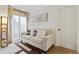 Cozy living room featuring a comfortable sofa and large windows with sheer curtains at 6165 Carrier Dr # 1206, Orlando, FL 32819