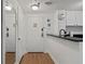 Apartment entryway with mirror, wood floors, and white door at 6165 Carrier Dr # 1206, Orlando, FL 32819