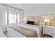 Spacious bedroom with a king-size bed, floral headboard, and two nightstands at 6165 Carrier Dr # 1206, Orlando, FL 32819