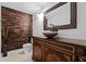 Elegant bathroom with a vessel sink, decorative mirror, and wood-paneled accent wall at 1306 Sweetwater Club Blvd, Longwood, FL 32779