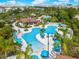 Expansive community pool with a cabana and ample seating under blue umbrellas at 4114 Breakview Dr # 406, Orlando, FL 32819