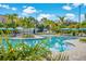 Large community pool with palm trees, blue umbrellas, and lounge chairs perfect for relaxation at 4114 Breakview Dr # 406, Orlando, FL 32819