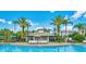 Community pool area with palm trees, lounge chairs, and a cabana for shade at 4114 Breakview Dr # 406, Orlando, FL 32819