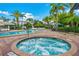Soothing hot tub surrounded by a paved patio and lush landscaping at 4114 Breakview Dr # 406, Orlando, FL 32819