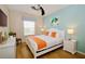 King-size bedroom with light wood floors and a ceiling fan at 4114 Breakview Dr # 406, Orlando, FL 32819