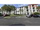Exterior view of an apartment building with balconies and parking at 4114 Breakview Dr # 406, Orlando, FL 32819