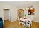 Bright dining area with a round table and chairs, hardwood floors, and access to kitchen at 4114 Breakview Dr # 406, Orlando, FL 32819