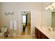 Bathroom with double vanity and access to bedroom and hallway at 4114 Breakview Dr # 406, Orlando, FL 32819