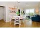 Dining room with white table and chairs, hardwood floors, and a view of the living room at 4114 Breakview Dr # 406, Orlando, FL 32819