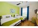 Bedroom with two twin beds, ceiling fan, and teal walls at 4114 Breakview Dr # 406, Orlando, FL 32819