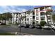 Exterior view of an apartment building with balconies and parking at 4114 Breakview Dr # 406, Orlando, FL 32819