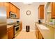 Modern kitchen with stainless steel appliances and light wood cabinets at 4114 Breakview Dr # 406, Orlando, FL 32819