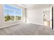 Bright bedroom with large window, plush carpeting, and access to a hallway at 815 Liliana Dr, Deland, FL 32724