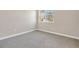 Simple bedroom with grey carpet, neutral walls, and a window with natural light at 815 Liliana Dr, Deland, FL 32724