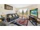 Living room with black leather couches, coffee table, and flat-screen TV at 5920 Norvale Ct, Orlando, FL 32808